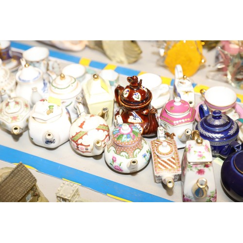 547 - Collection of miniature tea pots, cups & saucers