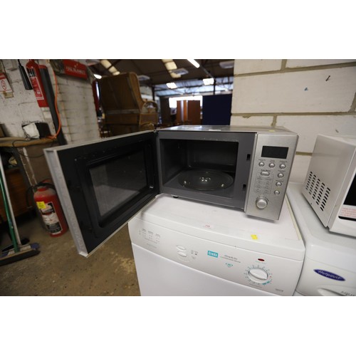 117 - Stainless microwave - warranted until 12 noon Tuesday following the above sale