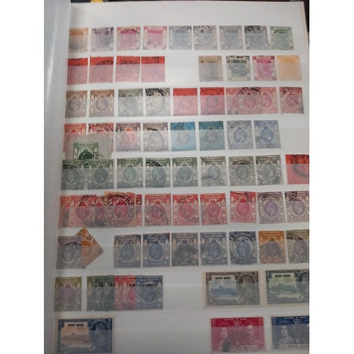 356 - 2 stock books & envelope of loose stamps - Hing Kong