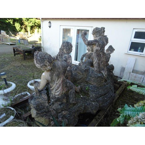 827 - Large carved ornament depicting 6 children playing on rocks a/f approximately 2.79 m wide