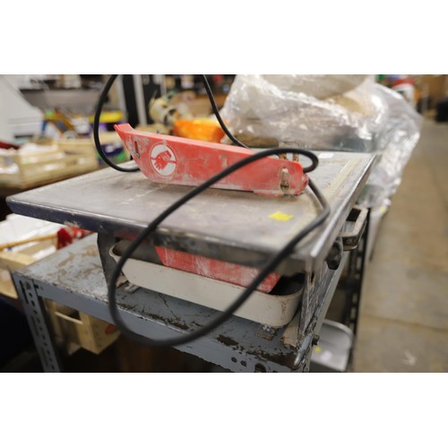 74 - Tile cutter - warranted until noon Tuesday following the above sale