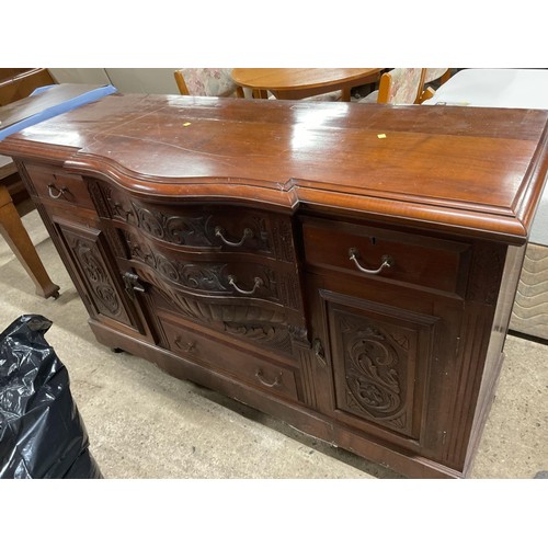 595 - Antique wooden serpentine front carved sideboard