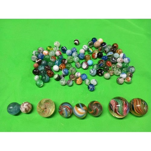 413 - Large qty of antique marbles, incl London bus tin