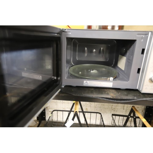 106 - Kenwood microwave - warranted until 12 noon Tuesday following the above sale