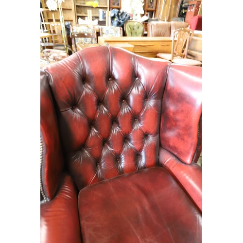 626 - Oxblood Red leather Button back wing armchair with footstool & cushion