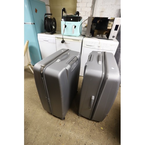 55 - 2 large grey suitcases