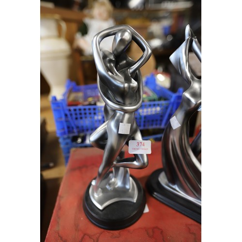 374 - Pair of silver coloured statues