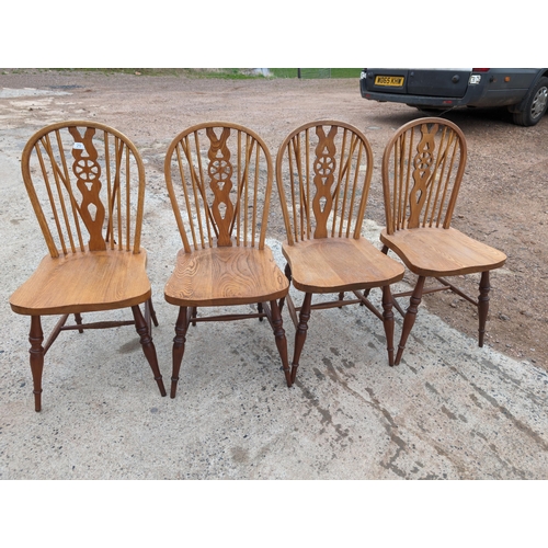 29 - Four Vintage Wheelback Dining Chairs
Good Used Condition - One Has Some Chew Marks On The Cross Memb... 