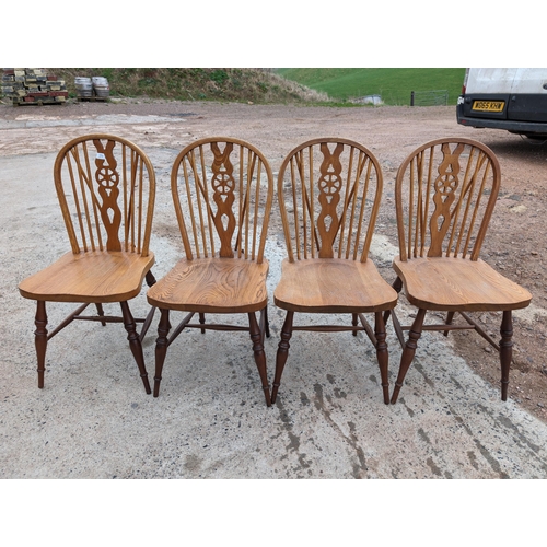 29 - Four Vintage Wheelback Dining Chairs
Good Used Condition - One Has Some Chew Marks On The Cross Memb... 