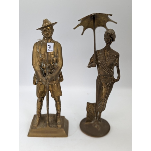 89 - Midcentury Pair Heavy Brass Ornaments - Lady With Umbrella Plus Solider Holding Rifle
10 x 32