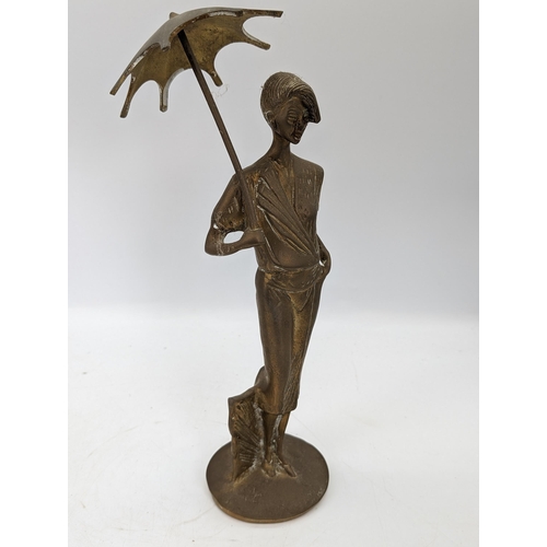 89 - Midcentury Pair Heavy Brass Ornaments - Lady With Umbrella Plus Solider Holding Rifle
10 x 32