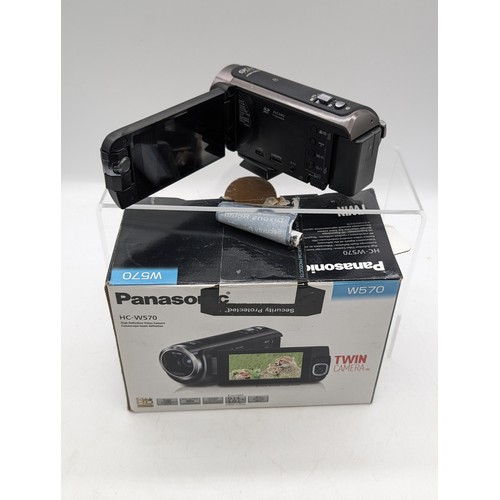 123A - Panasonic W570 Twin Camera Video Camera, Along with Binoculars, tripods and Others. Camera Tested Bu... 