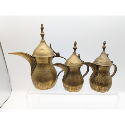 299 - Trio of Middle Eastern Brass Dallah Coffee Pots - Largest 17cm Smallest 13cm - Mark on the Base - Go... 