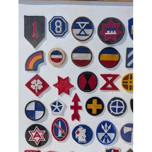 93 - Extensive and Well Framed Display of United States Military Shoulder Patches 78x70cm