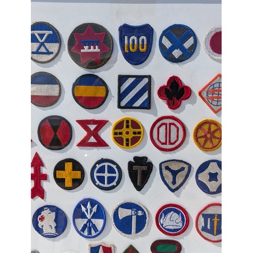 93 - Extensive and Well Framed Display of United States Military Shoulder Patches 78x70cm