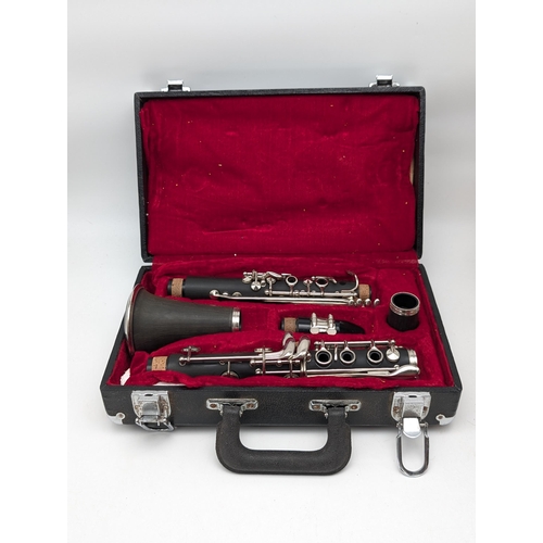 66 - Boxed Clarinet and a pair of Bongo's