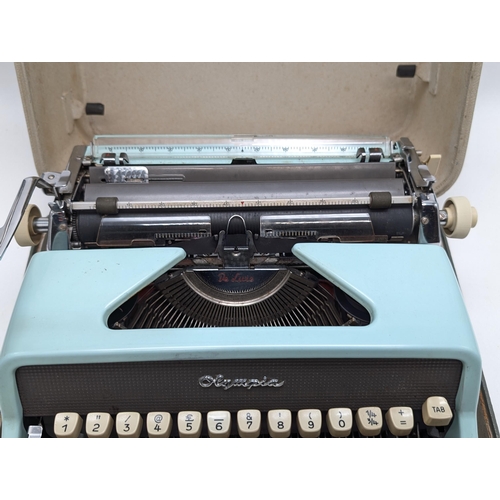 241 - Cased Duck Egg Blue Olypia Deluxe Typrewriter, Appears in Good order