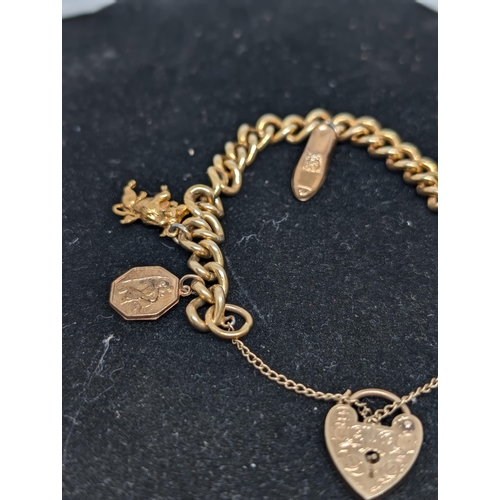 586 - 9Ct Gold Charm Bracelet with 4 Charms (all Hallmarked) with Heart Clasp. Weighing 26.07g.