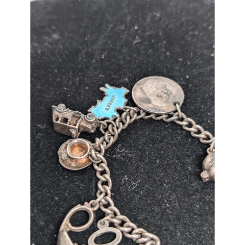 593 - Vintage Hallmarked Sterling Silver Charm Bracelet with 10 Charms attached. Weighing 37.5g