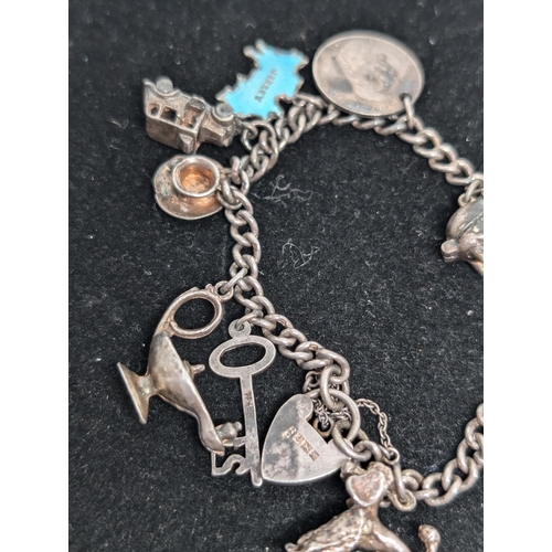 593 - Vintage Hallmarked Sterling Silver Charm Bracelet with 10 Charms attached. Weighing 37.5g