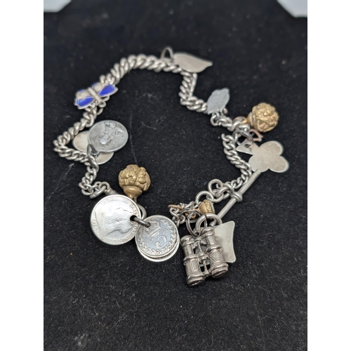 594 - Vintage Hallmarked Sterling Silver Charm Bracelet with 10 Charms attached. Weighing 57.34g