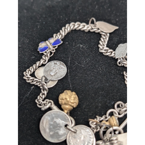 594 - Vintage Hallmarked Sterling Silver Charm Bracelet with 10 Charms attached. Weighing 57.34g