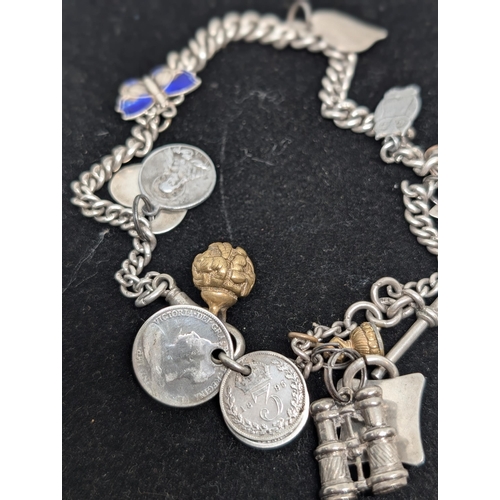 594 - Vintage Hallmarked Sterling Silver Charm Bracelet with 10 Charms attached. Weighing 57.34g