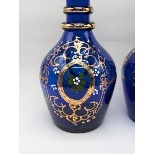 69 - Pair Attratcive Bohemian Blue Glass Decanters With Gilt Foliate and Stoppers. One Stopper Has Damage... 