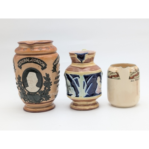 354 - Doulton Lambeth ‘General Gordon’ Commemorative Jug, Victorian Majolica Jug, and Motto Ware Jug (3)  ... 