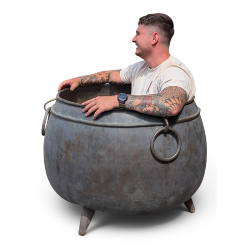 29 - Large copper garden planter or cauldron, of substantial bulbous form with rolled rim, triple iron ri... 