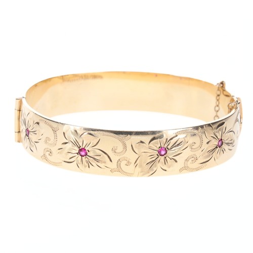 52 - 9ct Rolled Gold Bangle with Ruby Set Floral Design