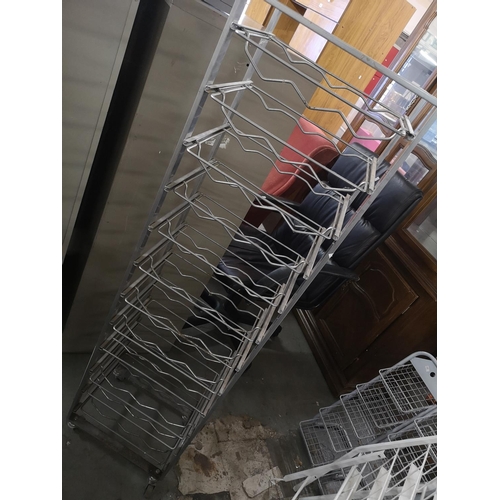 339 - Metal bottle holder with sliding shelves on wheels. Approx 140cm tall