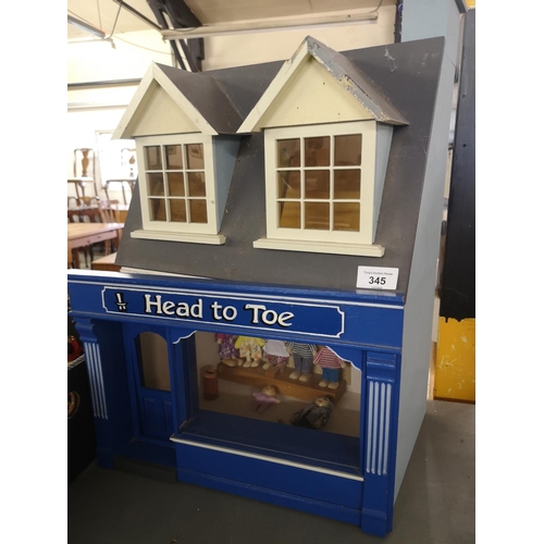 345 - Scratch built dolls house over shop with dolls. Approx 55cm tall