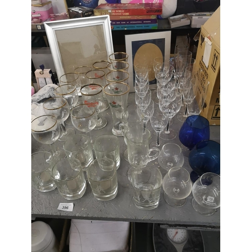 396 - Large collection of glasses incl. Calsberg glasses, wine glasses and champagne flutes