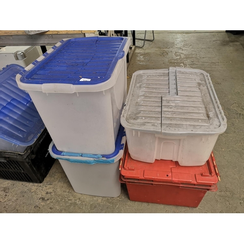 216 - Four large plastic storage boxes