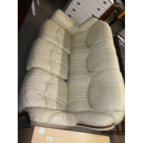 622 - Cream three seater leather sofa, 182 cm wide.