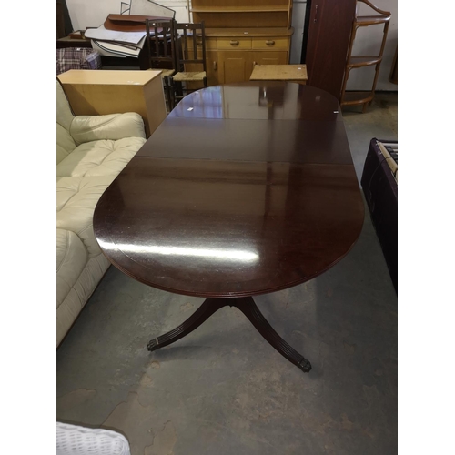 624 - Large mahogany extending veneer dining table on two pedestal legs with brass claw feet on castors, 1... 