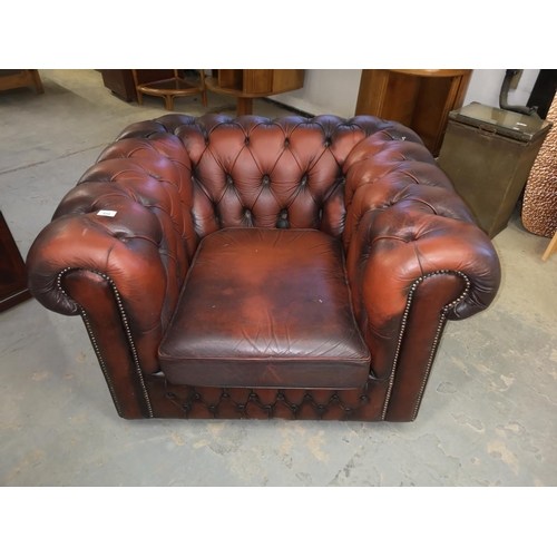 658 - Ox blood red leather Chesterfield chair, requires new castor.