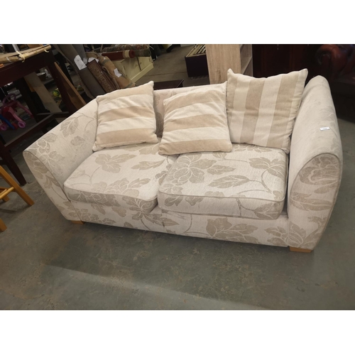 659 - Large cream floral patterned sofa with cushions, 195 cm wide approx.