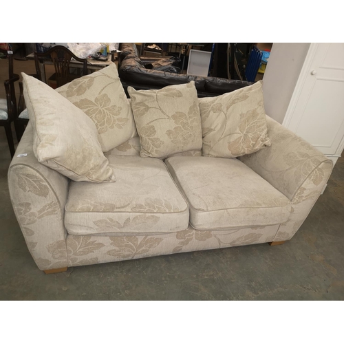 663 - Cream floral patterned two seater sofa,  cm wide approx.