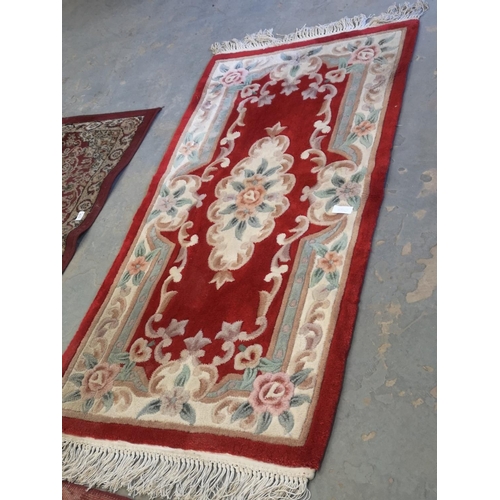 653 - Multi coloured oriental style rug, 5' x 2'6