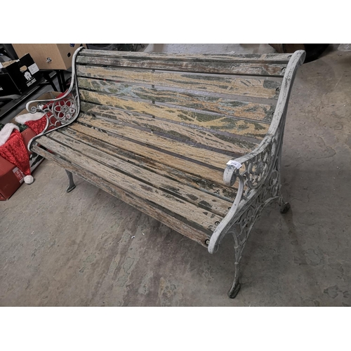228 - Garden bench with cast iron ends.