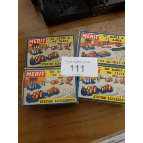 111 - Four matchbox size boxes of station accessories