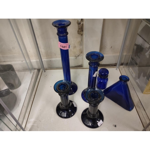 1581 - Collection of blue glass items including various sized candlesticks