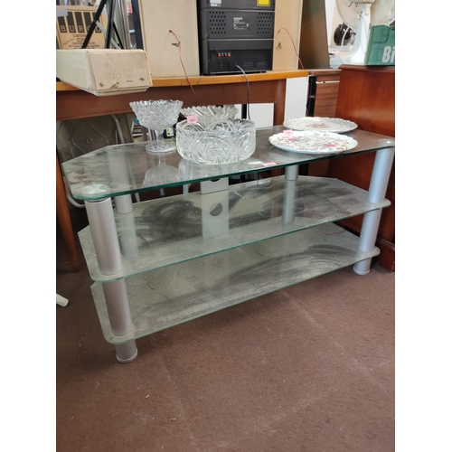 1652 - Large glass TV stand. Approximately 105 cm wide