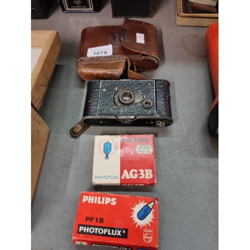 1079 - A vintage folding camera and leather case