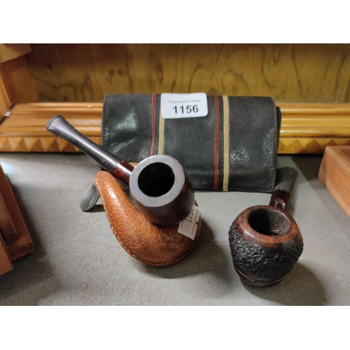 1156 - Two vintage pipes, a leather tobacco pouch, and pipe holder