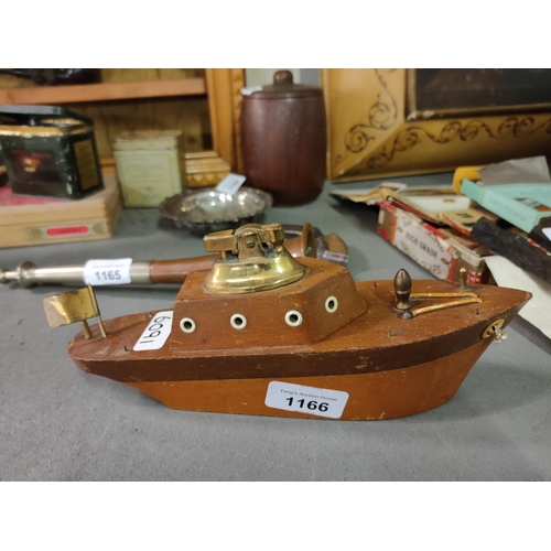 1166 - A retro cigarette light in the shape of a boat