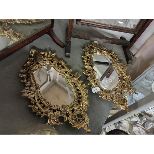 1182 - A pair of heavy guilt metal framed mirrors with etching detail to glass