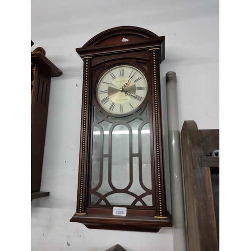 1245 - A wall hanging clock with quartz movement